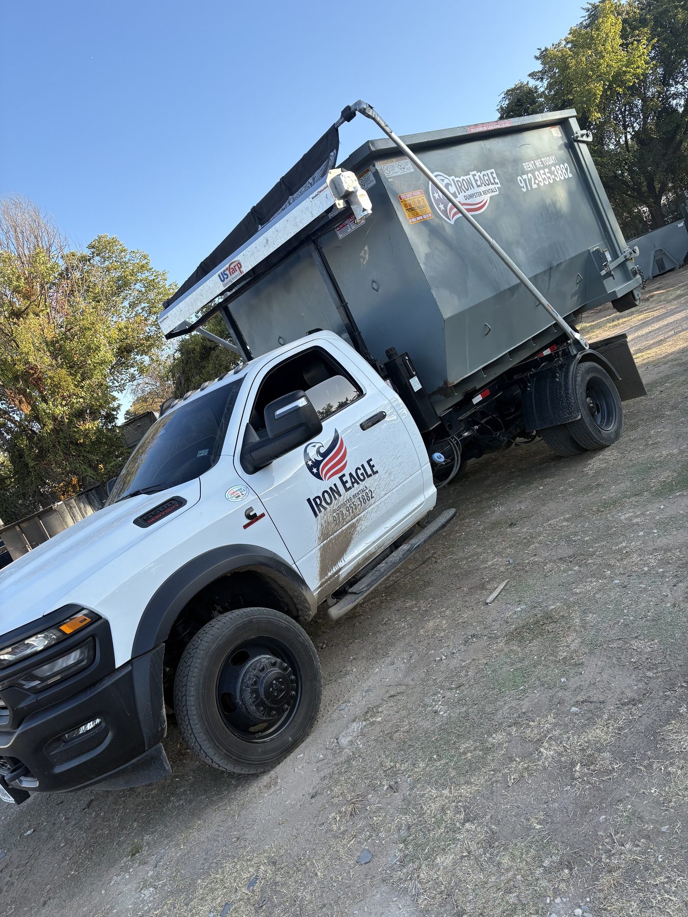 Iron Eagle Dumpster Rentals branded roll-off dumpster delivered to a residential driveway in Denton County